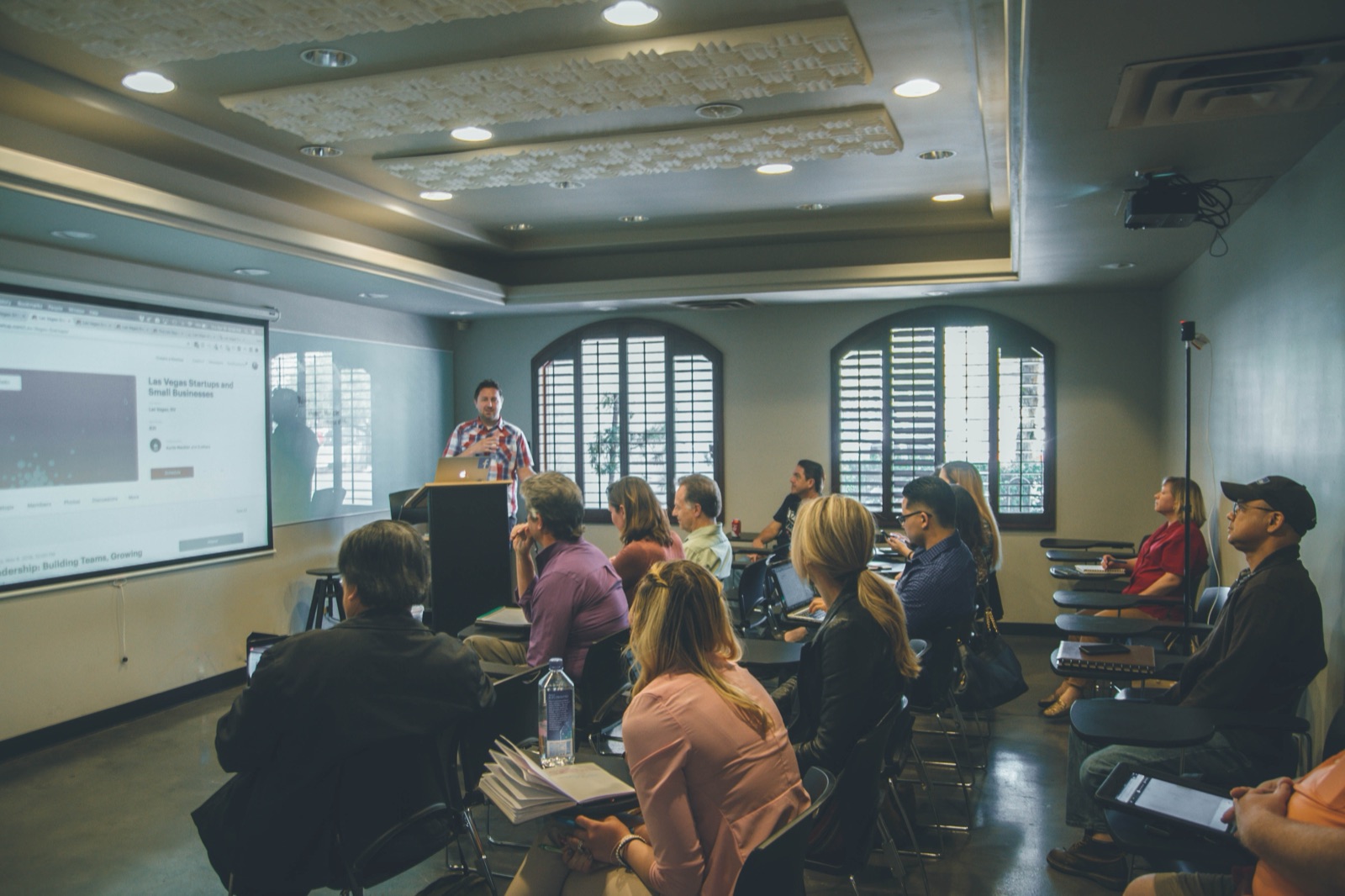 Instructor presenting to a group in a training room